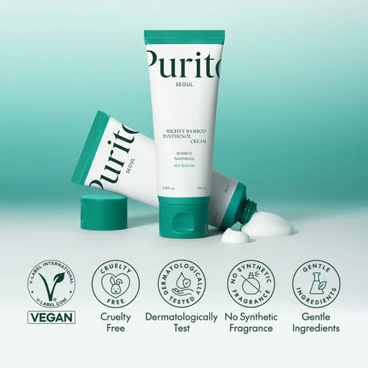 Tres tubos de crema hidratante Purito Panthenol descansando sobre superficie verde con logos vegano, cruelty free y otros